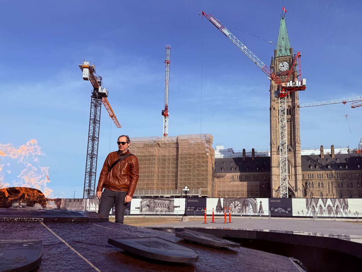 Standing near the Centennial Flame with Parliament Hill under construction behind