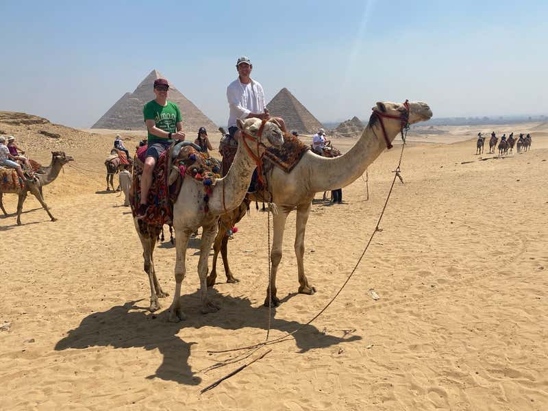Jon and I on camels with the pyramids behind us