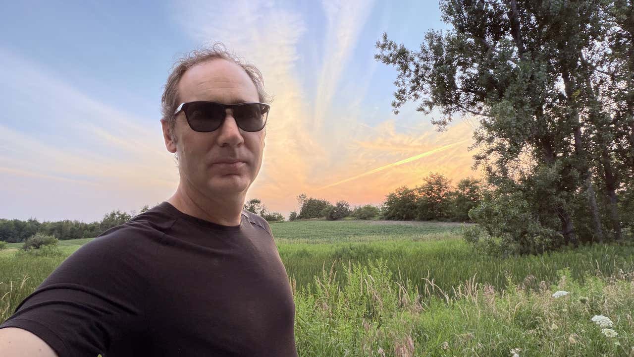 Joel at sunset in front of the fields at the farm