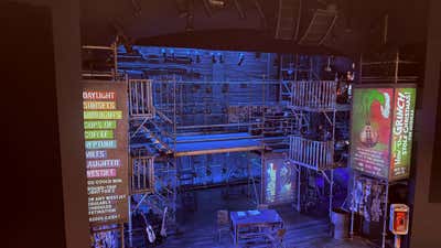 That set. All those levels and all that scaffolding, and the ensemble owns every inch of it.