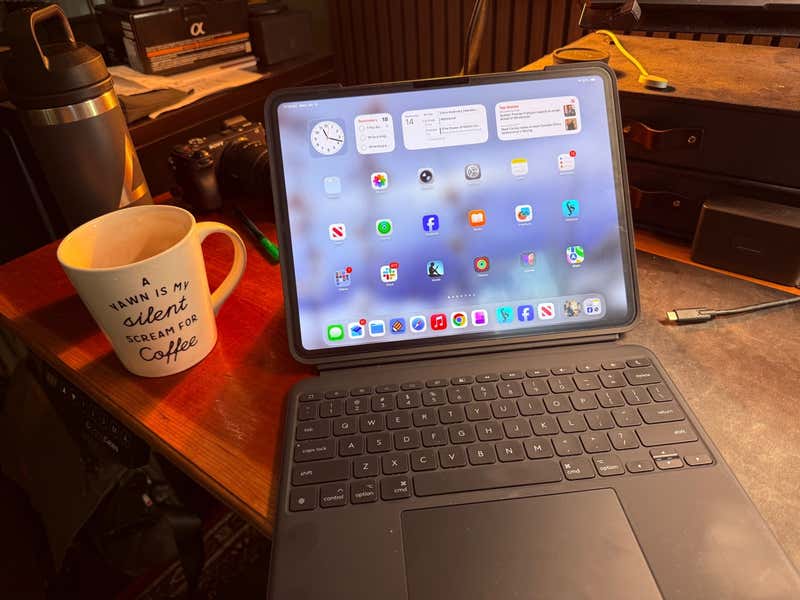 iPad workspace setup with keyboard and coffee