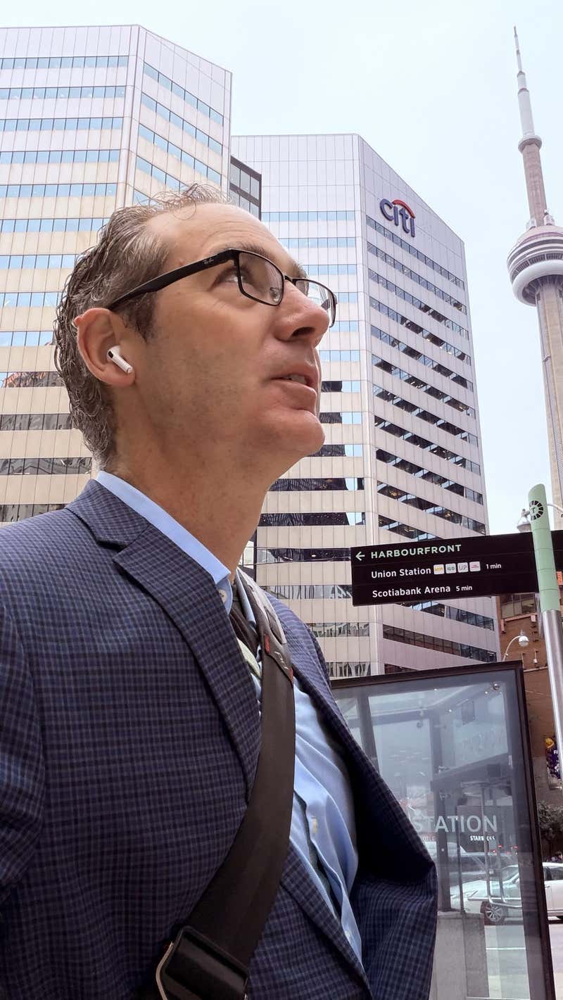 Joel looking up at the towers in downtown Toronto