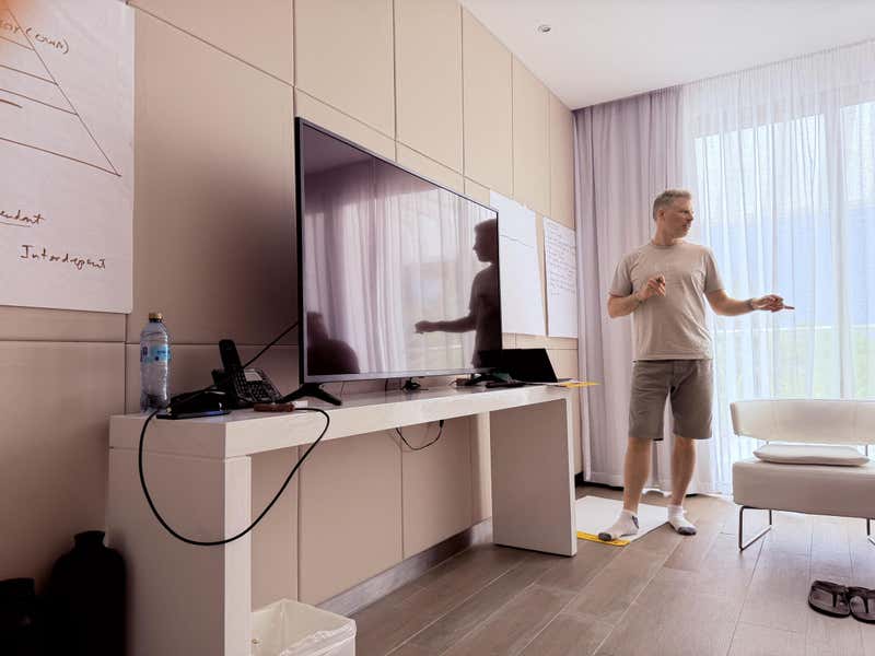 Jon leading a leadership session with whiteboards on the wall