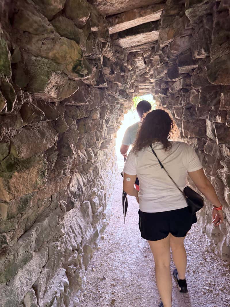 Walking through one of the stone tunnels at Tulum