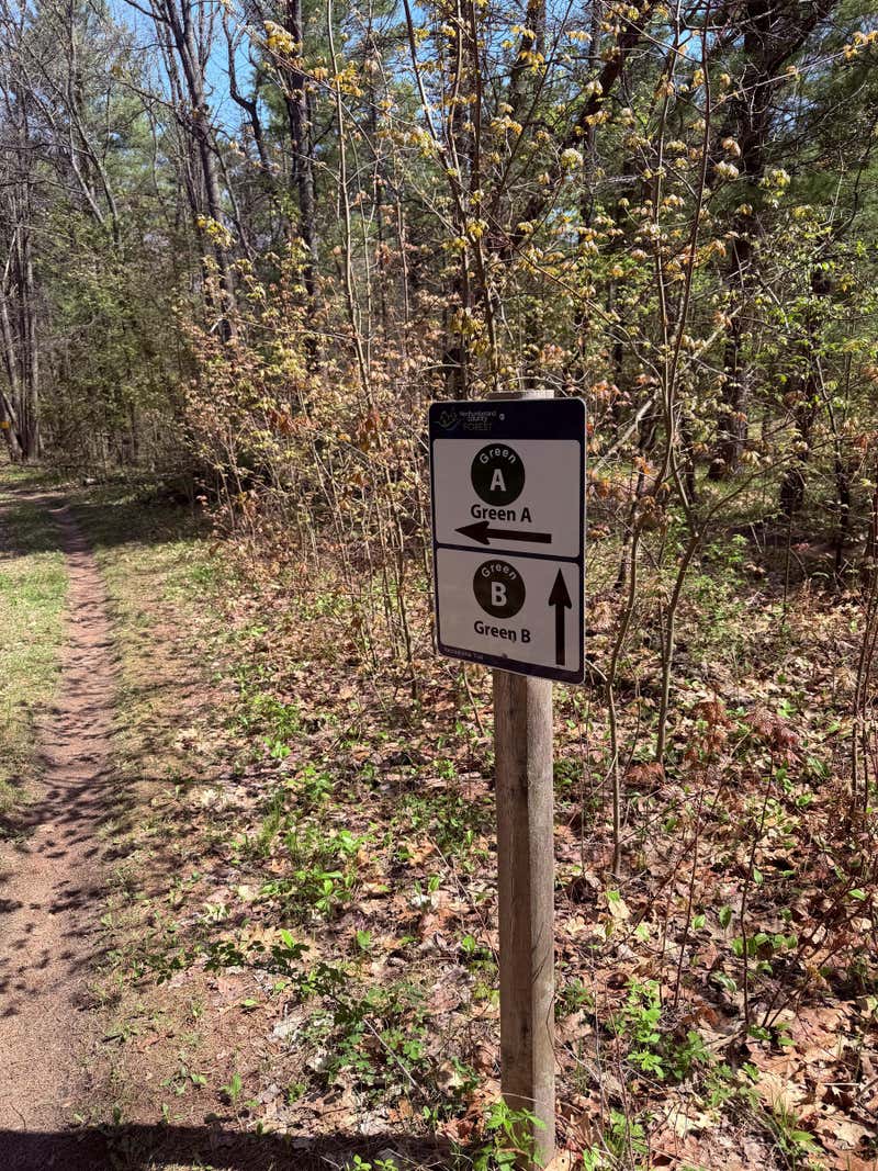 Northumberland County Forest trail sign with Green A pointing left and Green B straight ahead