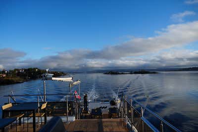 Ferry ride through the Oslo Fjord with Norwegian flag