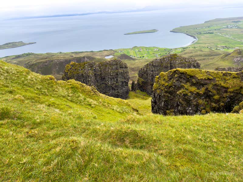 Looking down between two of the spiking rocks toward the loch and the village beyond