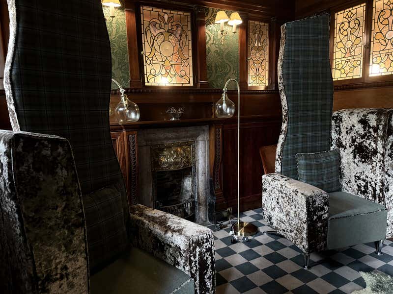 The sitting room at Skeabost, all stained glass and tartan and crushed velvet