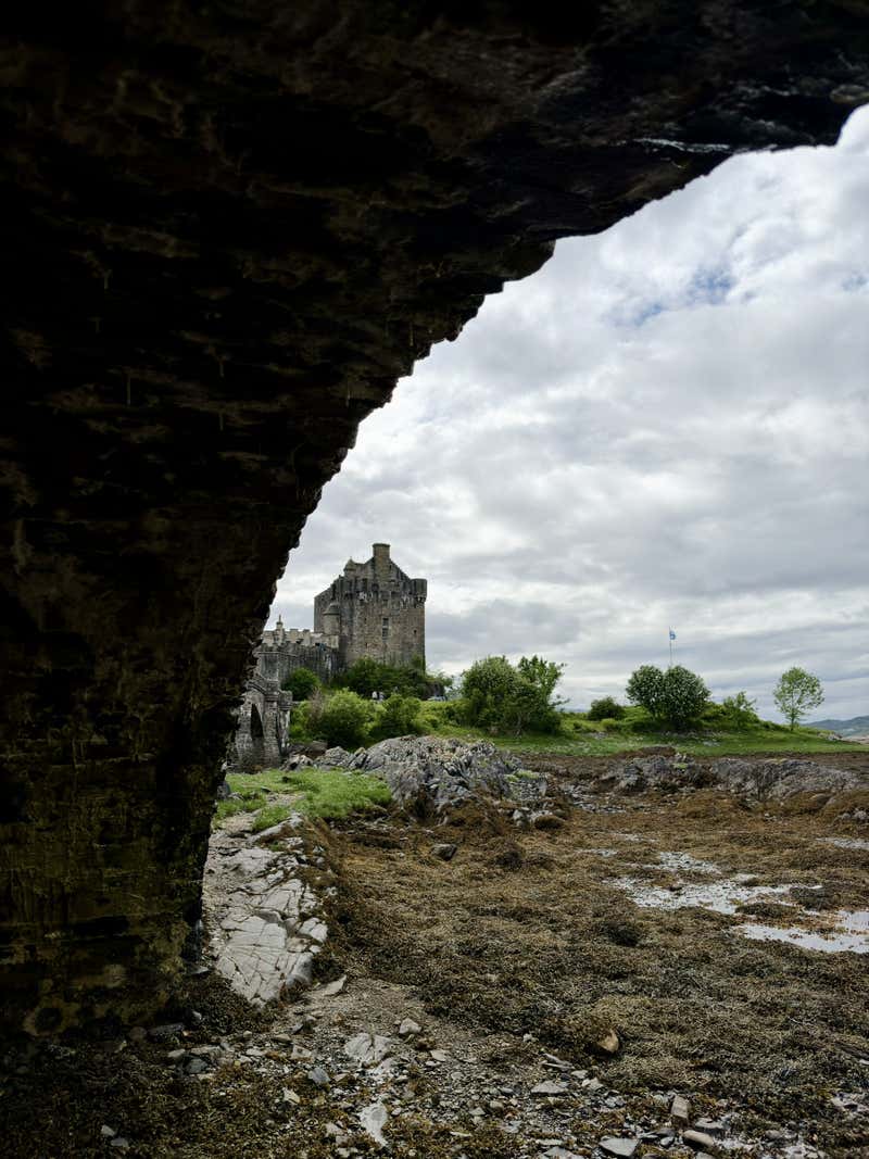 The castle framed through one of the stone archways