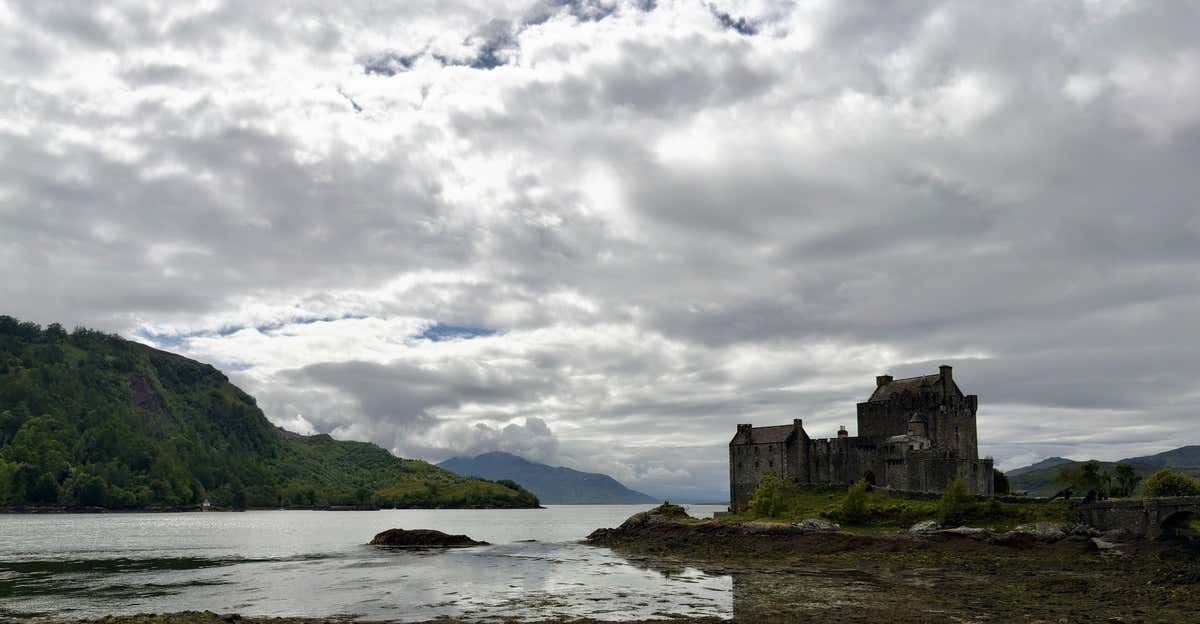 Eilean Donan Castle across the loch under a wide Highland sky