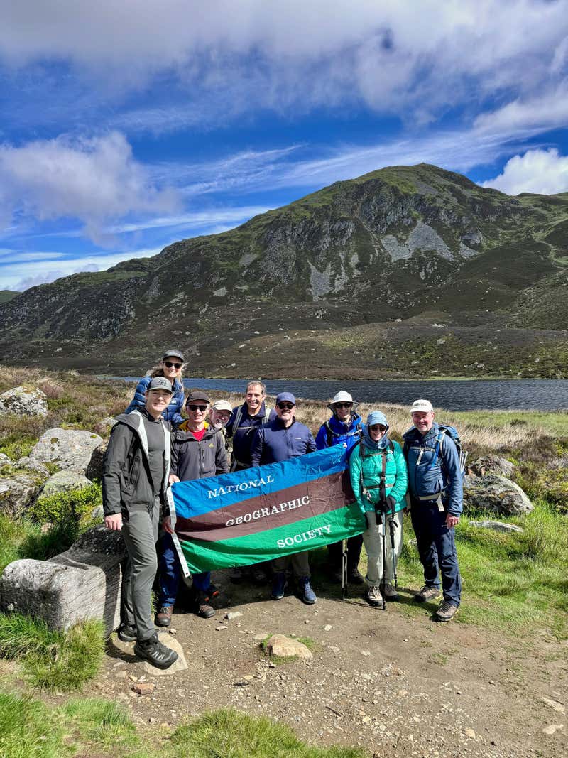 The group at Loch a' Choire with the National Geographic Society flag, photo courtesy of David