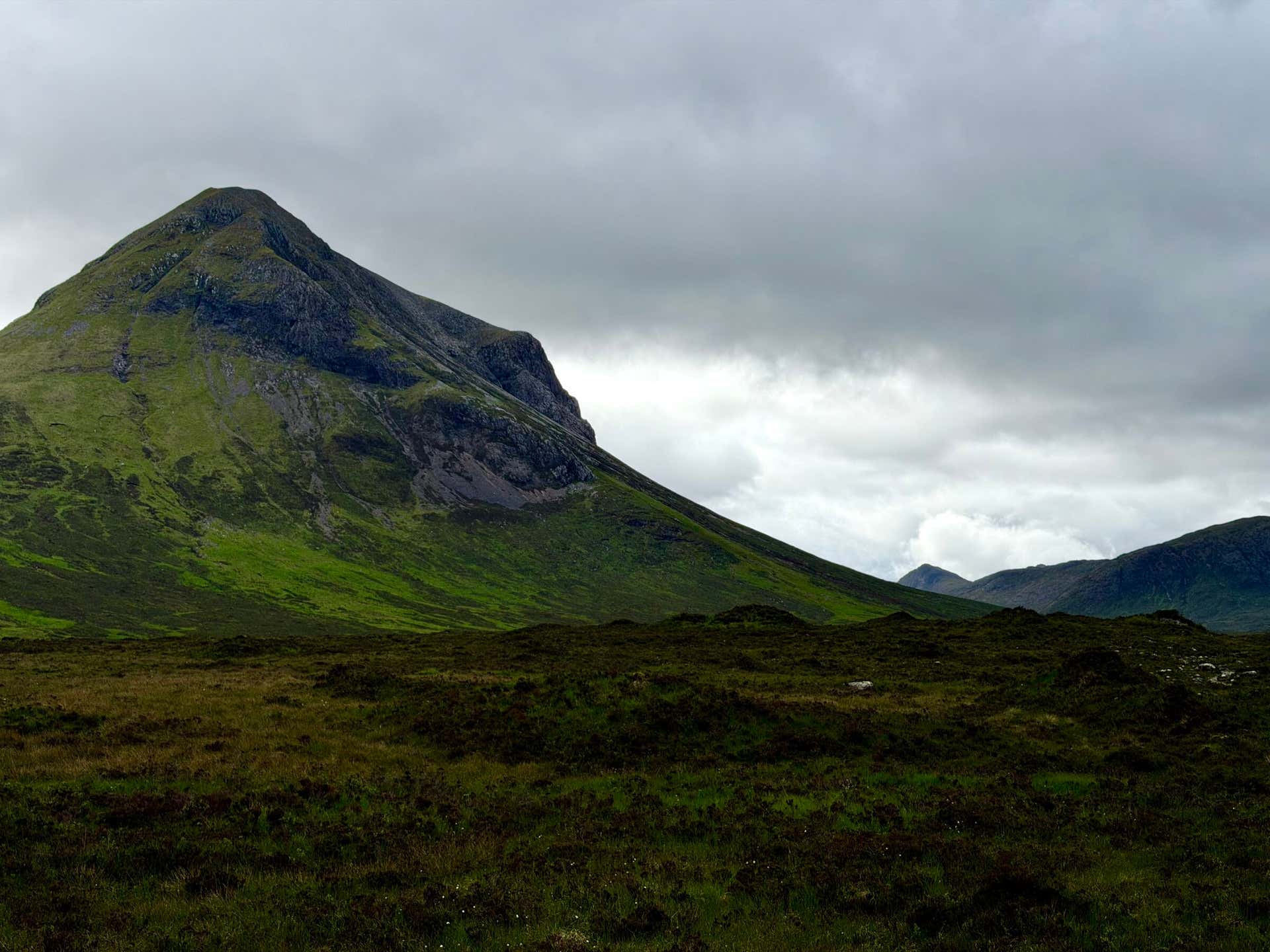 A single peak of the Cuillin rising green from the moor at Glen Sligachan