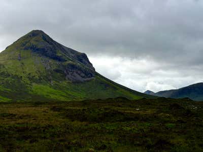 A single peak of the Cuillin rising green from the moor at Glen Sligachan