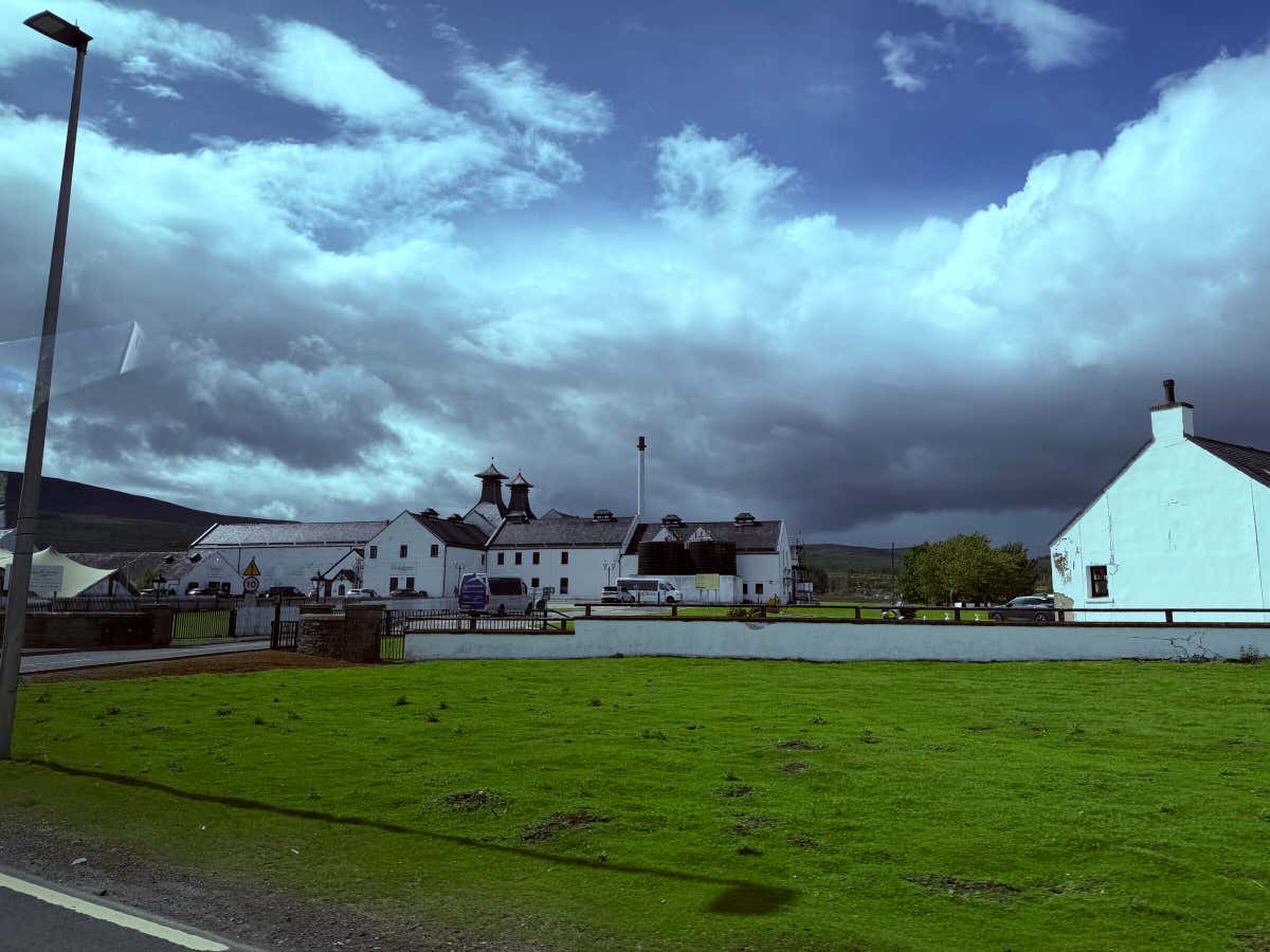 The white buildings of Dalwhinnie Distillery from the road, an old favourite