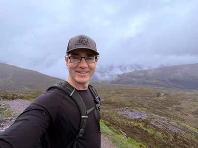 Joel at the top of the Devil's Staircase, the glen opening up behind him