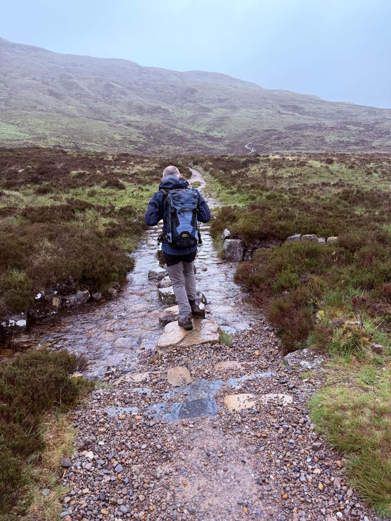 A hiker ahead of me on the flat at the top of the staircase