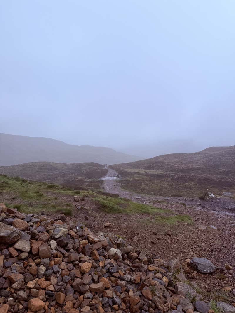 The scree slope ahead disappearing straight up into the cloud