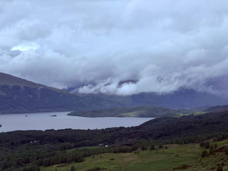 The cloud rolling down into the loch on the far shore