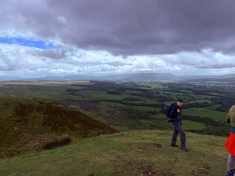 Pausing on a high point with the green patchwork rolling out behind us