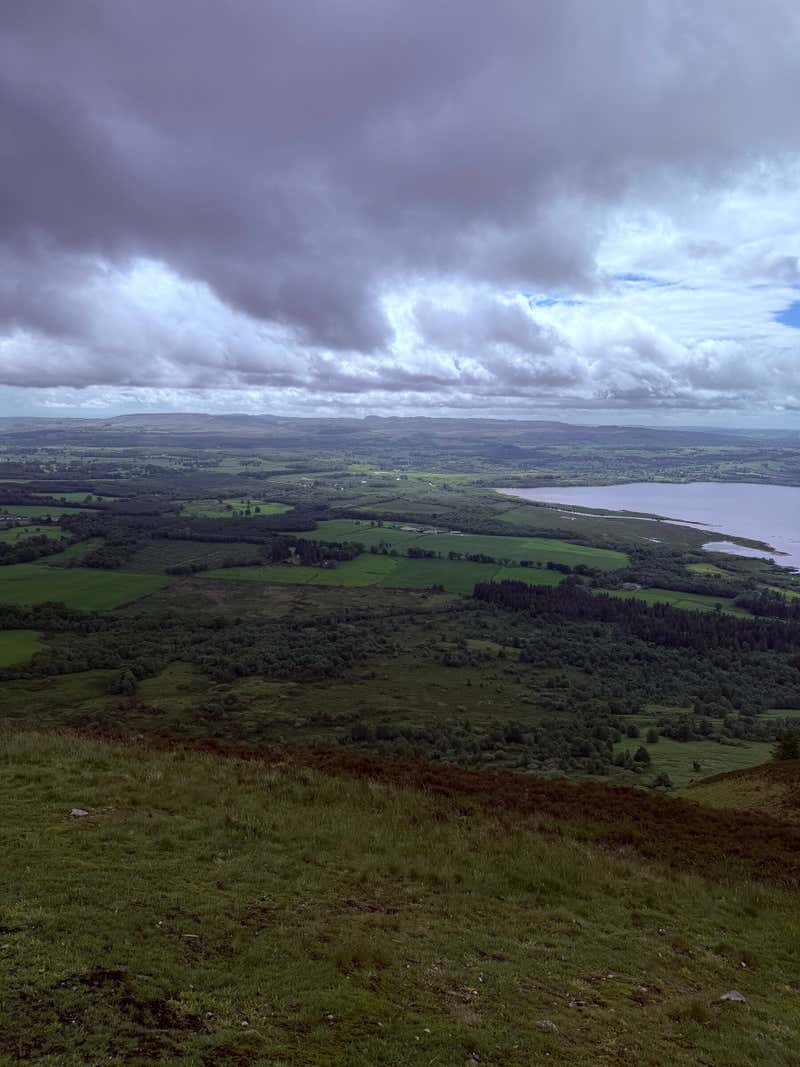 The wide panorama from the top with the loch and the islands stretched out below
