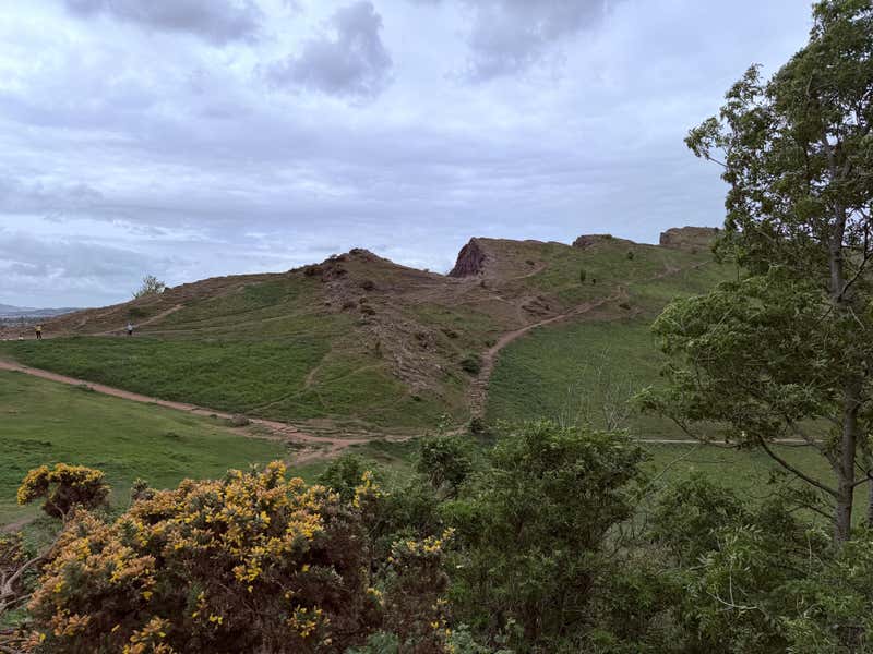 The rocky peak of Arthur's Seat from the trail below