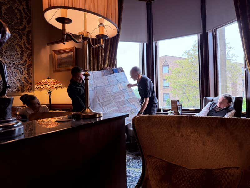 Gordon and Paul spreading out the map in the hotel lounge