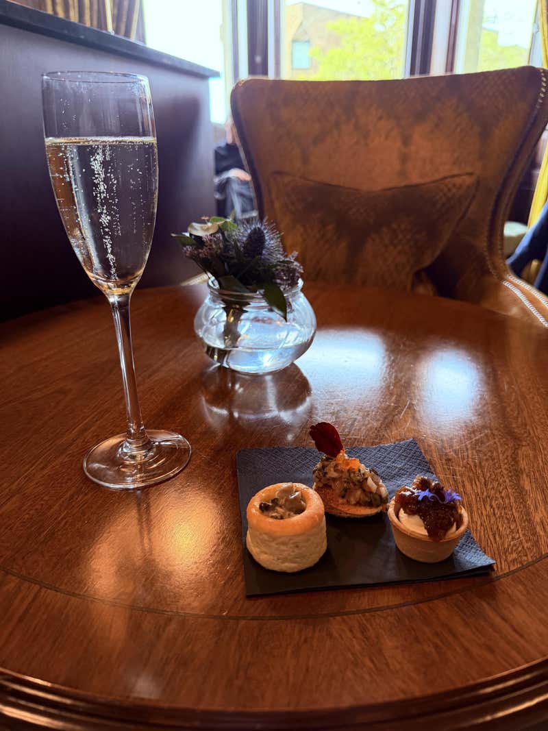 A welcome glass of prosecco and a trio of canapes at the Bonham