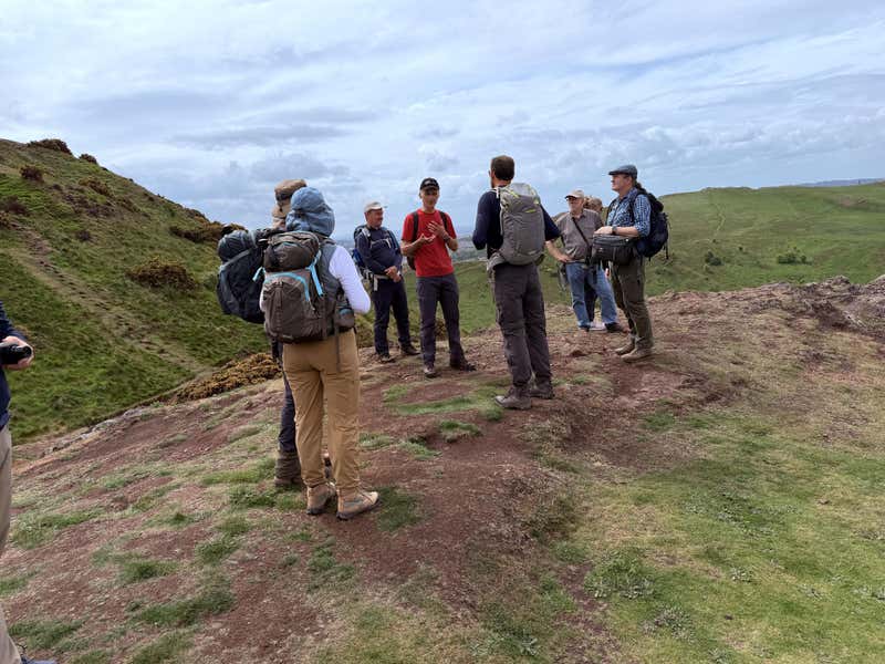 The group gathered on the ridge with Gordon mid-story