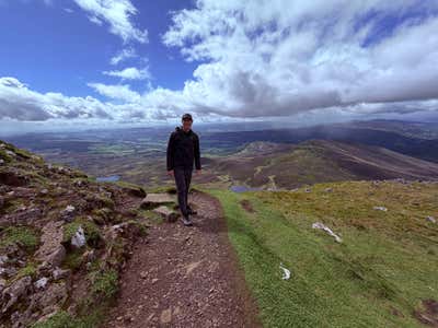 Joel on a Scottish summit, glen and lochs behind