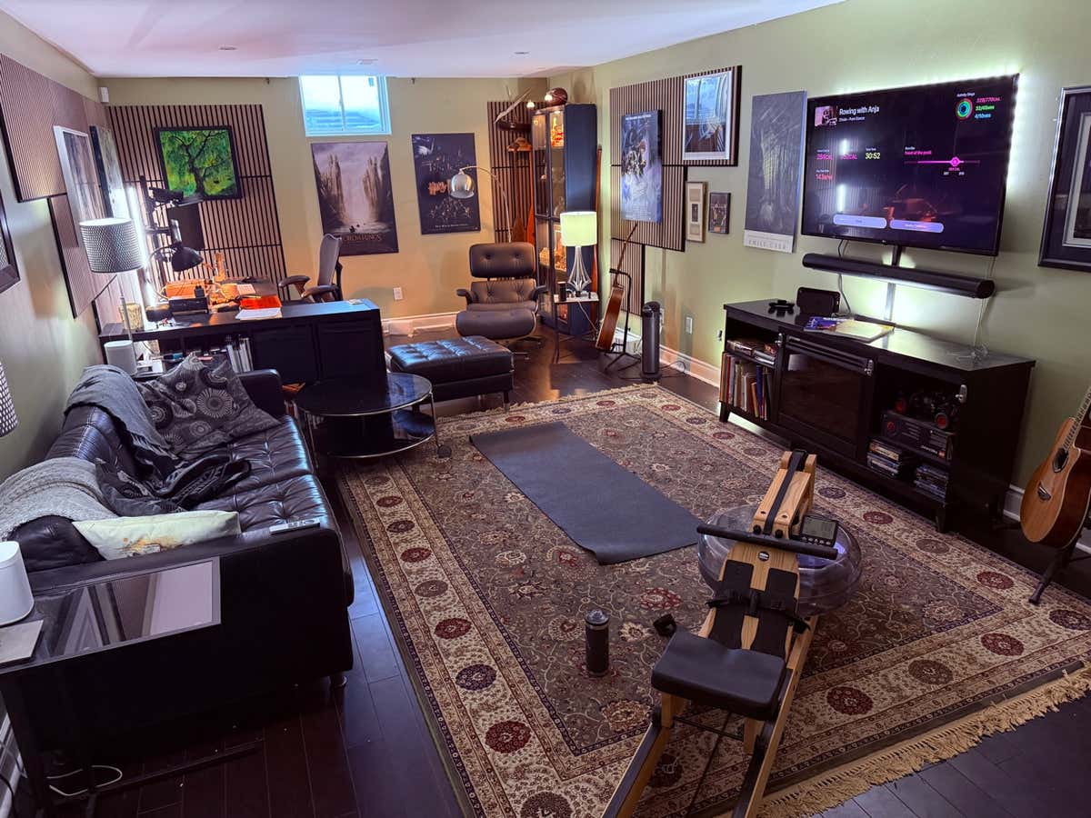 Home gym setup with WaterRower and Apple Fitness+ rowing workout on TV