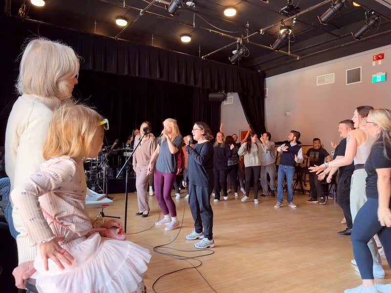 Val and her grandchild watching the cast rehearse at Sculthorpe Theatre