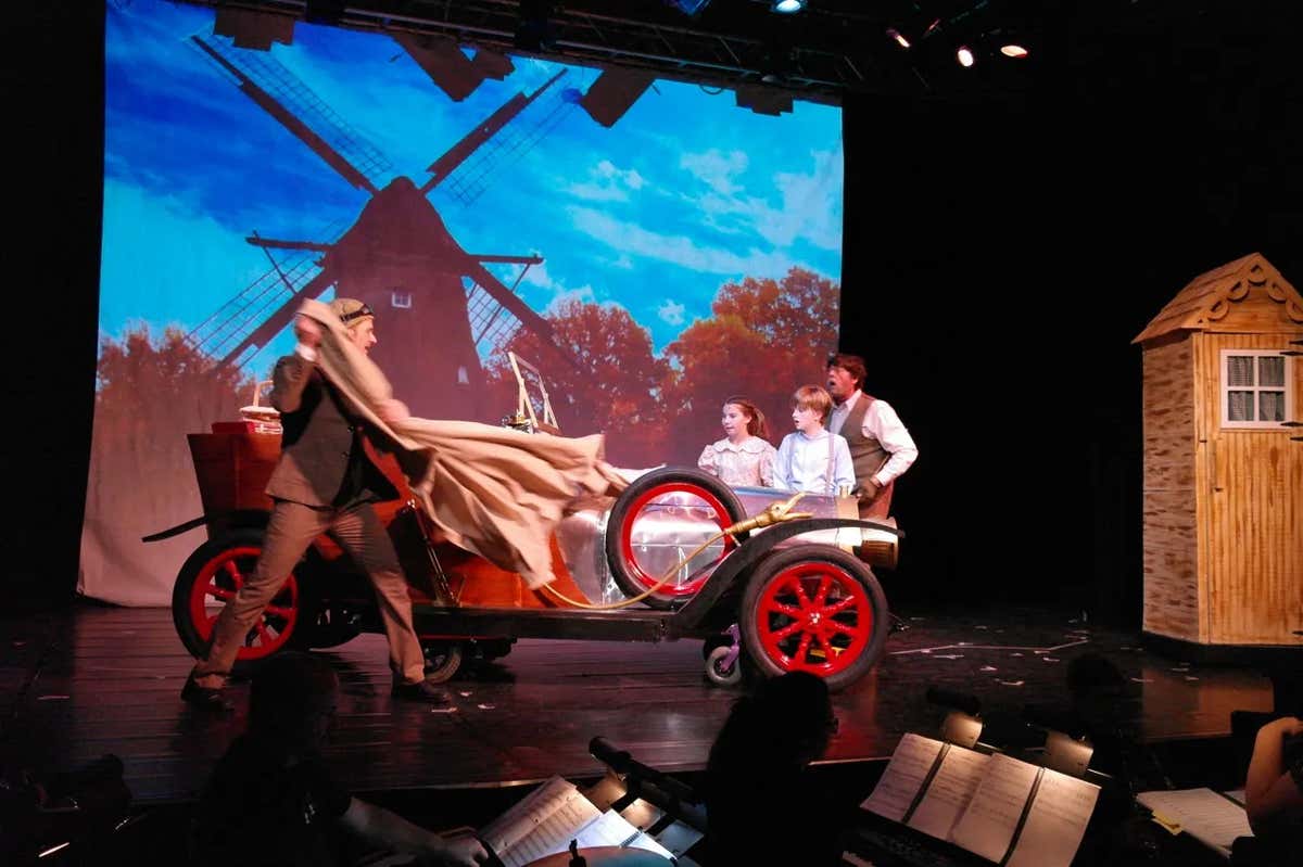 Chitty Chitty Bang Bang at VOS Theatre - the real car against a projected backdrop
