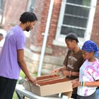 KCU osteopathic student plays board game with two children outside. 