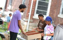 KCU osteopathic student plays board game with two children outside. 