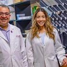  KCU researcher Ehab Sarsour, PhD, and fourth-year medical student Katiana Hebbert in white coats in a lab. 