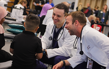 KCU students giving SVN student exam during Score 1 for Health Wellness Day