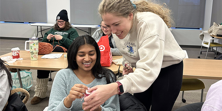 Stitches club members collaborate and support each other to create garments for donation to local organizations