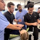 Three students and a professor test out new Butterfly ultrasound. 