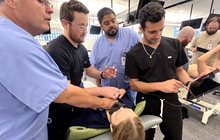 Three students and a professor test out new Butterfly ultrasound. 