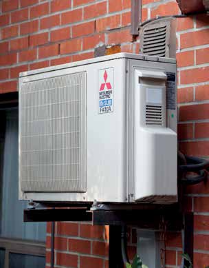 Mitsubishi Electric MUZ-FE12NA outdoor heat pump unit mounted on an exterior brick wall at Vilnius Manor