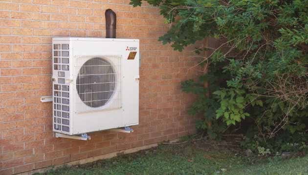 Mitsubishi Electric Zuba-Multi outdoor heat pump unit installed on a brick townhome at Trinity Glen