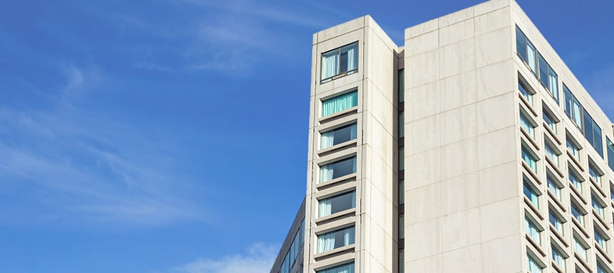 Multi-unit building exterior representing air-to-water heat pump fuel switching for low-carbon hydronic HVAC systems in Canadian buildings.