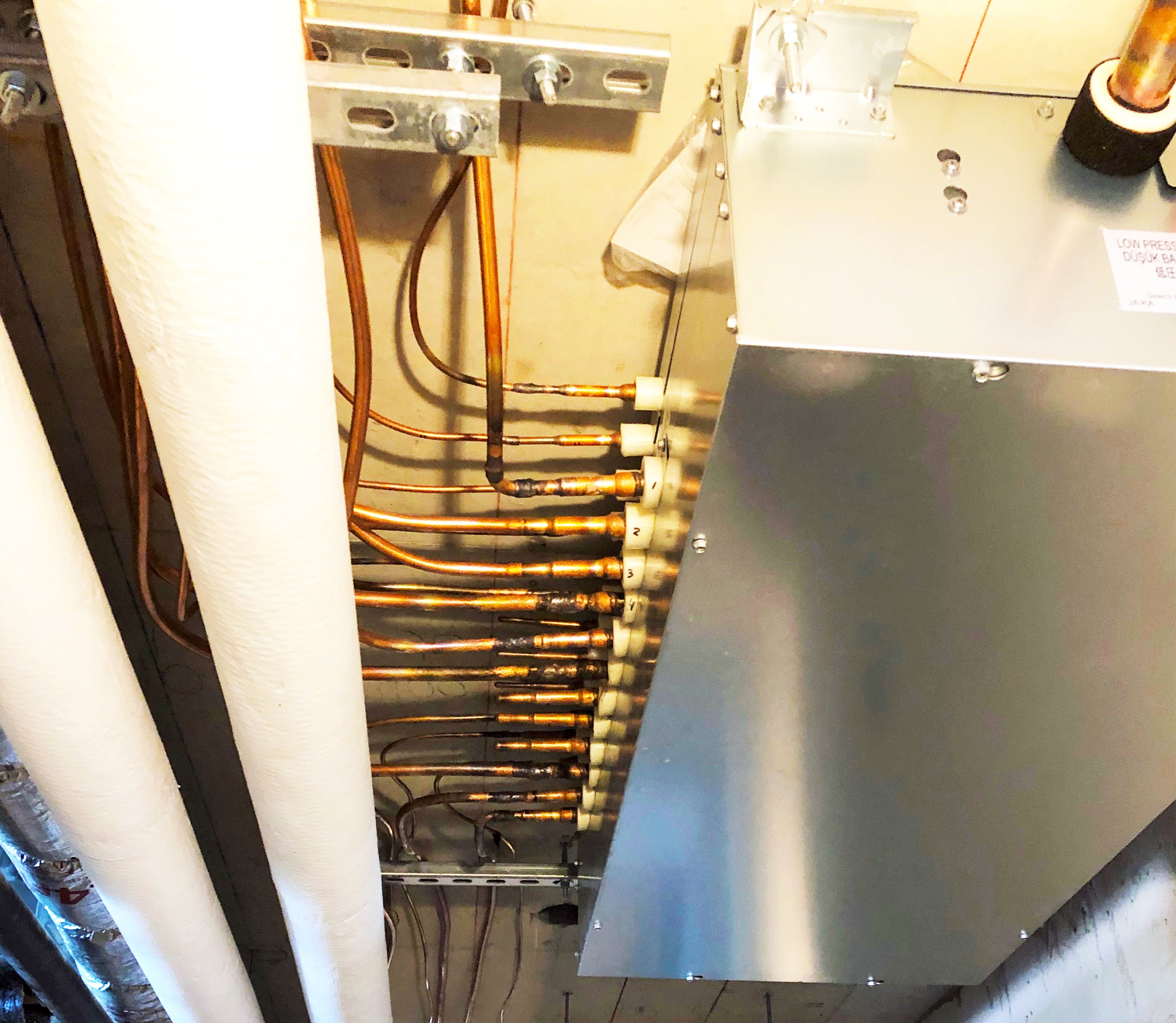 Mitsubishi Electric VRF mechanical equipment and copper refrigerant piping installed at the Aquabella condominium project.