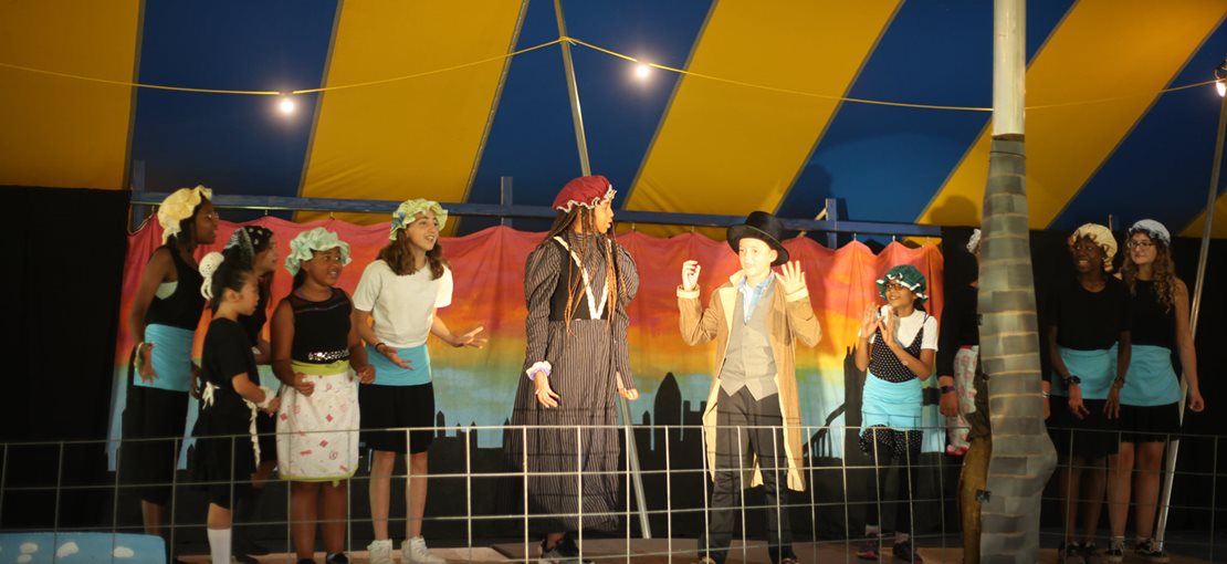 Performing under the colorful Big Top Tent!