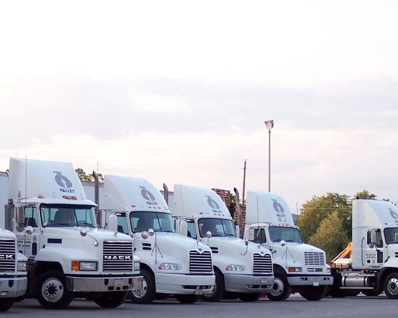 PRO Pallet delivery trucks parked outside the facility