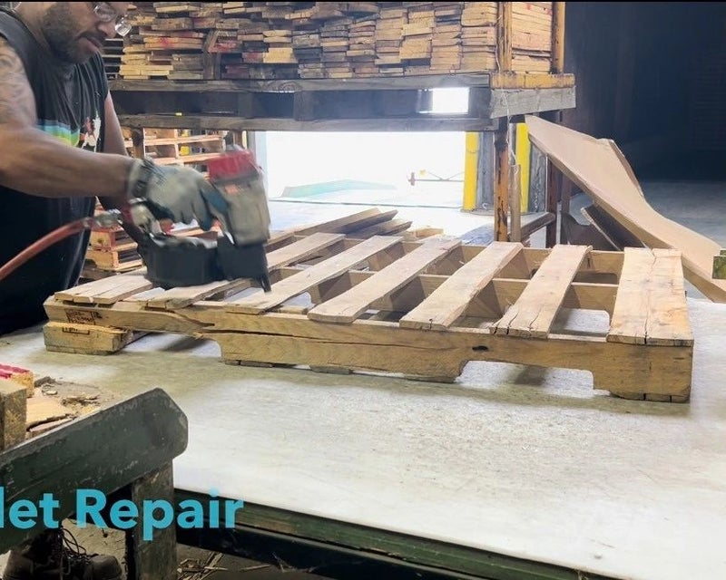 PRO Pallet team member repairing a wooden pallet