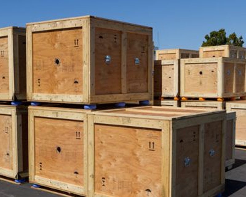 Custom wooden crates and pallet packaging staged for transport