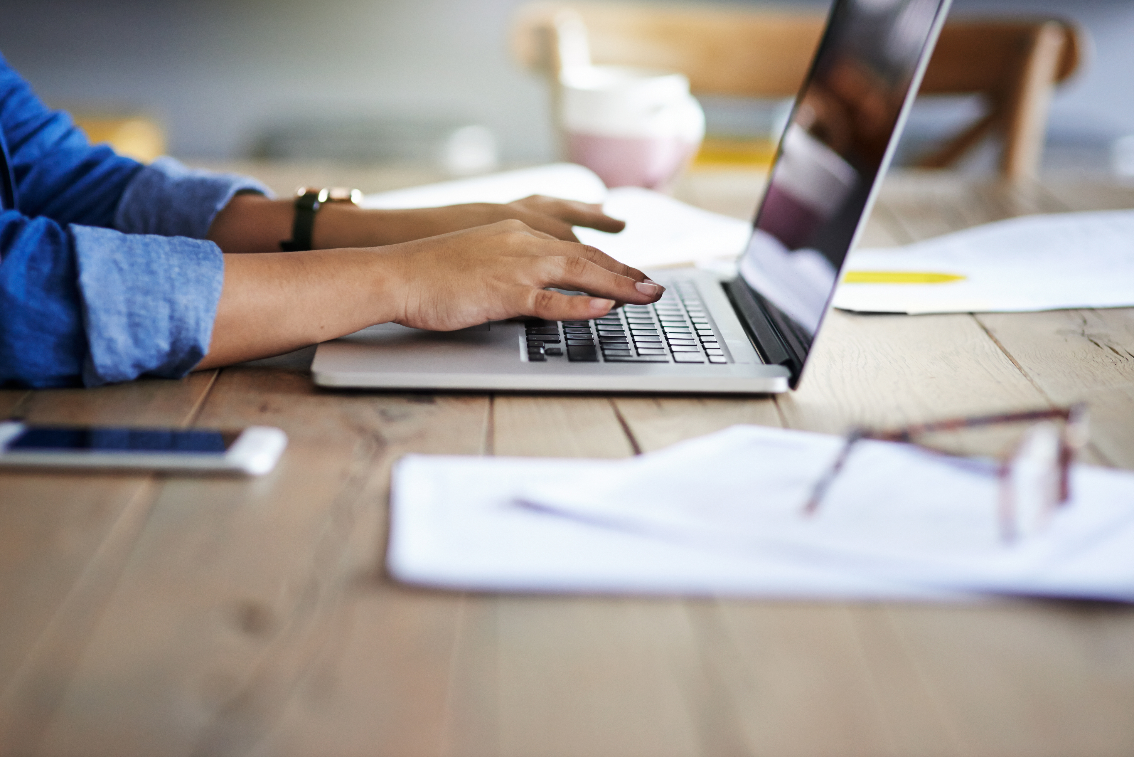 Cropped shot of a woman using a laptop while working from home.