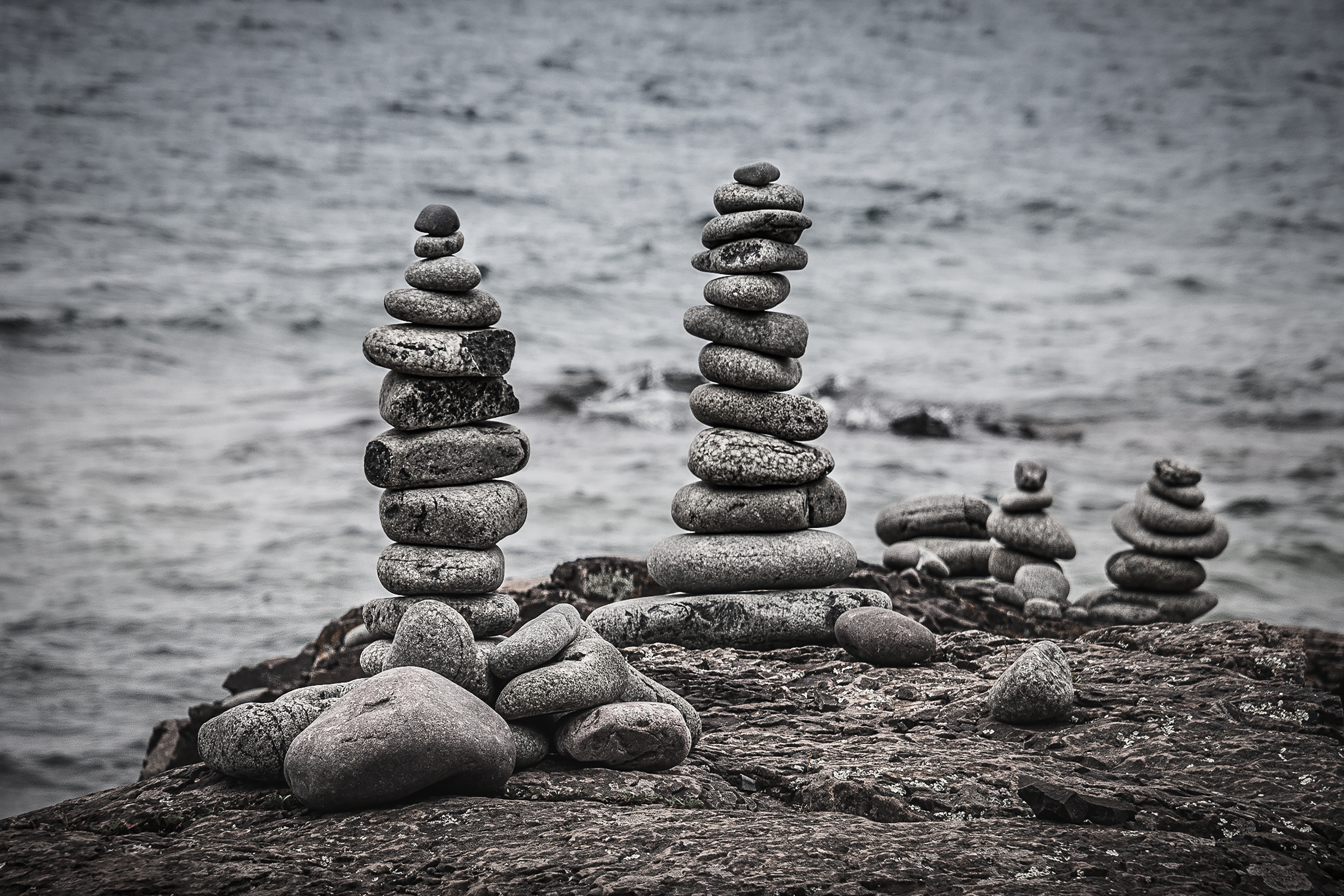 Multiple stacks of stone on the shore.