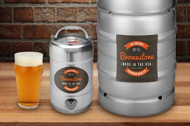 Two kegs of different sizes with the same custom keg label placed on each one of them.